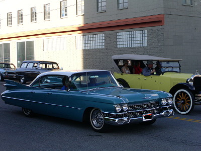 [A blue car with long tail fins and a white roof.]